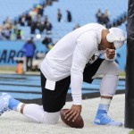 Carolina Panthers quarterback Cam Newton prays before the first half of an NFL divisional playoff football game against the Seattle Seahawks, Sunday, Jan. 17, 2016, in Charlotte, N.C. (AP Photo/Mike McCarn)