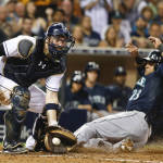 Seattle Mariners' Nelson Cruz scores as San Diego Padres catcher Derek Norris takes in a late throw during the ninth inning of the Mariners' 5-0 victory in a baseball game Tuesday, June 30, 2015, in San Diego.  (AP Photo/Lenny Ignelzi)