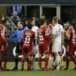 Head referee Daniel Radford, fourth from left, tries to separate Seattle Sounders and Club Tijuana players after a brief scuffle during the second half of an international friendly soccer match, Tuesday, March 24, 2015, in Seattle. The match ended in a 2-2 tie. (AP Photo/Ted S. Warren)