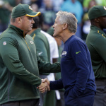 Green Bay Packers coach Mike McCarthy, left, shakes hands with Seattle Seahawks coach Pete Carroll before an NFL football game, Thursday, Sept. 4, 2014, in Seattle. (AP Photo/Elaine Thompson)