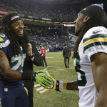 Seattle Seahawks cornerback Richard Sherman, left, greets Green Bay Packers cornerback Tramon Williams after the Seahawks defeated the Packers 36-16 in an NFL football game, Thursday, Sept. 4, 2014, in Seattle. (AP Photo/Stephen Brashear)