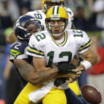 Seattle Seahawks defensive end Michael Bennett forces Green Bay Packers quarterback Aaron Rodgers to fumble in the second half of an NFL football game, Thursday, Sept. 4, 2014, in Seattle. A Packers player recovered the ball in the end zone, but was tackled for a safety on the play. (AP Photo/Scott Eklund)