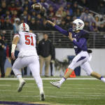 Washington quarterback Jake Browning, right, passes under pressure from Utah defensive end Jason Fanaika (51) during the first half of an NCAA college football game, Saturday, Nov. 7, 2015, in Seattle. (AP Photo/Ted S. Warren)