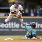 San Diego Padres second baseman Alexi Amarista leaps to get out of the way of sliding Seattle Mariners' James Jones (99) at second base in the fourth inning in a baseball game Monday, June 16, 2014, in Seattle. Jones was forced out, but Robinson Cano was safe at first base on a fielder's choice. (AP Photo/Elaine Thompson)