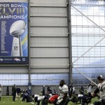 Seattle Seahawks players stretch near a Super Bowl XLVIII banner touting their victory over the Denver Broncos during NFL football practice, Wednesday, Jan. 6, 2016, in Renton, Wash. (AP Photo/Ted S. Warren)