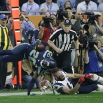 Seattle Seahawks cornerback Jeremy Lane (20) is tackled by New England Patriots wide receiver Julian Edelman (11) after intercepting New England Patriots quarterback Tom Brady during the first half of NFL Super Bowl XLIX football game Sunday, Feb. 1, 2015, in Glendale, Ariz. (AP Photo/Kathy Willens)