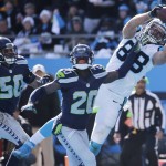 Carolina Panthers tight end Greg Olsen (88) makes a touchdown catch against Seattle Seahawks cornerback Jeremy Lane (20) during the first half of an NFL divisional playoff football game, Sunday, Jan. 17, 2016, in Charlotte, N.C. (AP Photo/Chuck Burton)
