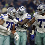 Dallas Cowboys' Greg Hardy (76) is congratulated by Morris Claiborne (24) and Tyron Smith after intercepting a pass from Seattle Seahawks quarterback Russell Wilson in the second half of an NFL football game Sunday, Nov. 1, 2015, in Arlington, Texas. (AP Photo/Brandon Wade)
