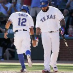 Texas Rangers' Rougned Odor (12) is congratulated by designated hitter Prince Fielder (84) after scoring a run after Shin-Soo Choo was walked with the bases loaded during the fifth inning of a baseball game against the Seattle Mariners, Monday, April 4, 2016, in Arlington, Texas. (AP Photo/Brandon Wade)