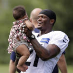 Seattle Seahawks Will Blackmon smiles as he looks at his daughter, Jade Blackmon, 7 months, after an NFL football training camp Monday, Aug. 3, 2015, in Renton, Wash. (AP Photo/Elaine Thompson)