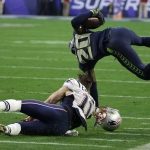 New England Patriots wide receiver Julian Edelman (11) tackles Seattle Seahawks cornerback Jeremy Lane (20) after an interception during the first half of NFL Super Bowl XLIX football game Sunday, Feb. 1, 2015, in Glendale, Ariz. (AP Photo/David J. Phillip)