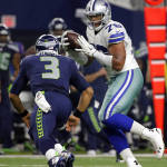 Seattle Seahawks quarterback Russell Wilson (3) runs to tackle Dallas Cowboys' Greg Hardy (76) who intercepted a pass from Wilson in the second half of an NFL football game Sunday, Nov. 1, 2015, in Arlington, Texas. (AP Photo/Brandon Wade)
