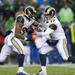 St. Louis Rams quarterback Case Keenum (17) hands off to Todd Gurley against the Seattle Seahawks in the second half of an NFL football game, Sunday, Dec. 27, 2015, in Seattle. The Rams won 23-17. (AP Photo/John Froschauer)