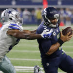 Dallas Cowboys cornerback Byron Jones (31) drives Seattle Seahawks' Russell Wilson (3) out of bounds after Wilson kept the ball for a run in the second half of an NFL football game Sunday, Nov. 1, 2015, in Arlington, Texas. (AP Photo/Brandon Wade)