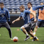 Seattle Sounders forward Jordan Morris (13) dribbles in front of Nelson Valdez as Nathan Sturgis (18) looks on during a soccer training session Monday, Feb. 22, 2016, in Seattle. The Sounders play Club America in the CONCACAF Champions League quarterfinal round on Tuesday. (AP Photo/Elaine Thompson)