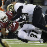Washington State running back Keith Harrington (24) is brought down by Colorado linebacker Kenneth Olugbode (31) and defensive end Timothy Coleman during the second half of an NCAA college football game, Saturday, Nov. 21, 2015, in Pullman, Wash. Washington State won 27-3. (AP Photo/Young Kwak)