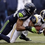 Seattle Seahawks' K.J. Wright (50) brings down St. Louis Rams' Tavon Austin on a carry in the first half of an NFL football game, Sunday, Dec. 27, 2015, in Seattle. (AP Photo/John Froschauer)