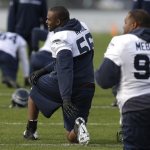 Seattle Seahawks defensive end Cliff Avril, center, stretches during warmups before NFL football practice on Wednesday, Jan. 15, 2014, in Renton, Wash. (AP Photo/Ted S. Warren)