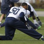 Seattle Seahawks outside linebacker K.J. Wright stretches during warmups Wednesday, Jan. 15, 2014, before NFL football practice in Renton, Wash. The Seahawks will play the San Francisco 49ers Sunday in the NFC championship. (AP Photo/Ted S. Warren)