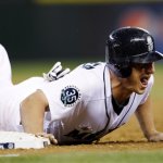 Seattle Mariners' Kyle Seager safely dives back to first base on a pick-off attempt by the Boston Red Sox during the third inning of a baseball game Wednesday, Sept. 5, 2012, in Seattle. (AP Photo/Elaine Thompson)