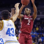 
              Washington State guard Ike Iroegbu, right, shoots as UCLA guard Jonah Bolden defends during the first half of an NCAA college basketball game, Saturday, Jan. 30, 2016, in Los Angeles. (AP Photo/Mark J. Terrill)
            