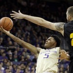 
              Washington's Dejounte Murray (5) lays in a shot past Arizona State's Eric Jacobsen during the second half of an NCAA college basketball game Wednesday, Feb. 3, 2016, in Seattle. (AP Photo/Elaine Thompson)
            